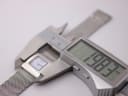 Digital caliper measuring the Tissot L610K watch case, displaying a precise measurement of 19.82mm.