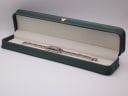 The Gucci 3900 L watch resting inside a generic green leatherette presentation box.