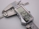 Digital caliper measuring the Gucci 3900 L case diameter, displaying an exact measurement of 12.22 mm.