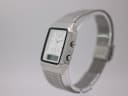 Right side profile view of the Citizen C480 ana-digi watch, showcasing the square case and mesh bracelet on a display stand.