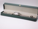The Citizen C480 watch laid out inside a green leatherette display box with a small gold crown emblem.
