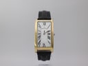 Front view of Maurice Lacroix gold-plated rectangular watch with white dial and black Roman numerals on a black leather strap.