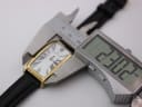 Digital caliper measuring the watch case width at 23.30mm, showing the white dial.
