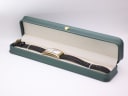 The Maurice Lacroix watch laid inside a green leatherette studio presentation box.