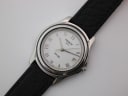 Overhead view of Tissot PR 50 watch with black leather strap on a white surface.
