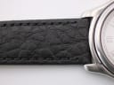 Close-up of the textured black leather strap and its connection to the watch lugs.