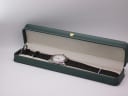Tissot PR 50 watch with black leather strap displayed in a green presentation box.