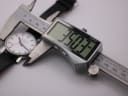 Digital caliper displaying a precise case diameter measurement of 35.03mm on the Mondaine watch.