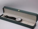 The Mondaine watch presented in a generic green display box (studio prop, not original).
