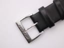 Close-up of the polished stainless steel buckle, signed "MONDAINE".