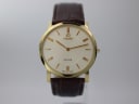 Front view of Roamer Slim Line watch with gold-tone case, cream dial, and brown leather strap on a white background.