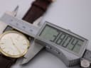 Digital caliper measuring the case diameter of the Roamer Slim Line watch at 38.04mm.