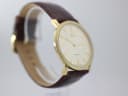 Another angled side view of the Roamer Slim Line watch, highlighting the case profile and brown leather strap.