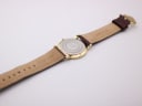 View of the Roamer Slim Line watch from above, focusing on the case back and the underside of the brown leather strap.