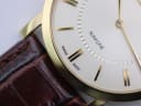 Extreme close-up of the Roamer Slim Line dial at 6 o'clock, showing "SWISS MADE" text and the cream dial texture.