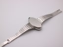 View of the case back of the Mortima watch, revealing the brushed finish and the integrated steel bracelet.