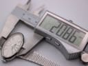 Digital caliper measuring the width of the integrated steel bracelet where it connects to the Mortima watch case, showing 20.86mm.