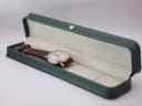 Bulova watch resting inside a generic green presentation box.