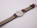 Rear view of the brown crocodile-effect leather strap, showing the 'genuine leather' stamp and '20' lug width marking.