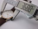Digital caliper measuring the Bulova watch case diameter at 36.88mm.