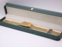 The gold-tone Seiko watch displayed in a generic green leatherette presentation box (studio prop).
