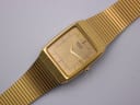 Close-up, angled view of the gold-tone Seiko dial with its minimalist indices and 'SEIKO QUARTZ' branding.