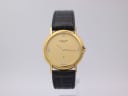 Front view of gold Favre-Leuba watch with gold dial and diamond markers on black leather strap.