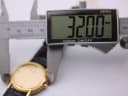 Digital caliper measuring the watch case diameter at 32.00mm.