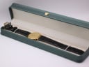 Favre-Leuba watch lying in the green studio presentation box, angled view.