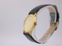 Side profile view of the gold Favre-Leuba watch on a display stand, showing the crown and case thickness.