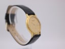 Angled side view of the gold Favre-Leuba watch on a display stand, highlighting the case shape.