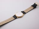 Back view of the watch showing the stainless steel case back with '1975' engraving and the black leather strap.