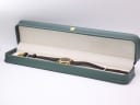 The Raymond Weil 9923 watch presented inside a generic green leatherette display box, a studio prop.