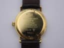 Close-up of the gold case back, clearly showing 'Raymond Weil Geneve', '18K Gold Electroplated', 'Waterresistant 10M', and model number '9923' engravings.
