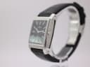 Angled view of Rotary Revelation watch showing black dial, textured case side, and crown.