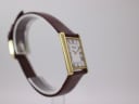 Opposite angled side view of the Raymond Weil watch highlighting the slender gold case.
