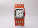 Front view of Nixon Mini GTO watch with white dial and brown leather cuff strap.