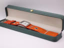 The Nixon watch displayed in a green presentation box.