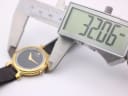 Digital caliper measuring the watch case diameter at 32.06mm.