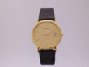 Front view of the gold octagonal Bulova quartz watch with a gold sunburst dial and black leather strap.