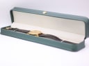 Side view of the Bulova watch displayed in a green presentation box.