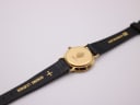 Rear view of the Gucci watch, showing the case back engraving "3000.2.L" and "GENUINE LEATHER" on the strap.