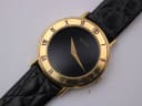 Close-up front view of the Gucci watch dial, revealing the gold "GUCCI" text, hands, and "SWISS MADE" at 6 o'clock.