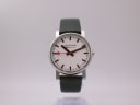 Front view of Mondaine Official Swiss Railways watch with white dial, black markers, red seconds hand, and green leather strap.