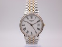 Front view of Tissot T870/970 two-tone watch with white dial, black roman numerals, and date window.