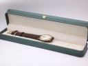 The Raymond Weil watch resting in a generic green leatherette display box.