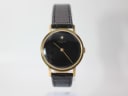 Front view of the gold-tone Raymond Weil 7000 watch with a black dial and black leather strap.