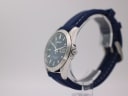 Side profile view of the Seiko V743-9A20, showing the polished silver case, crown, and navy rubber strap on a clear stand.