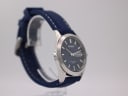 Angled side view of the Seiko V743-9A20, highlighting the blue dial, silver case, and the texture of the navy rubber strap.