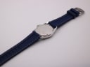 Rear view of the Seiko watch laid flat, displaying the stainless steel case back and the full length of the navy rubber strap.